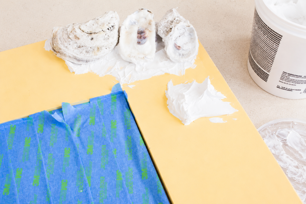 glueing the  oystr shells How To Make An Oyster Shell Mirror You’ll Love