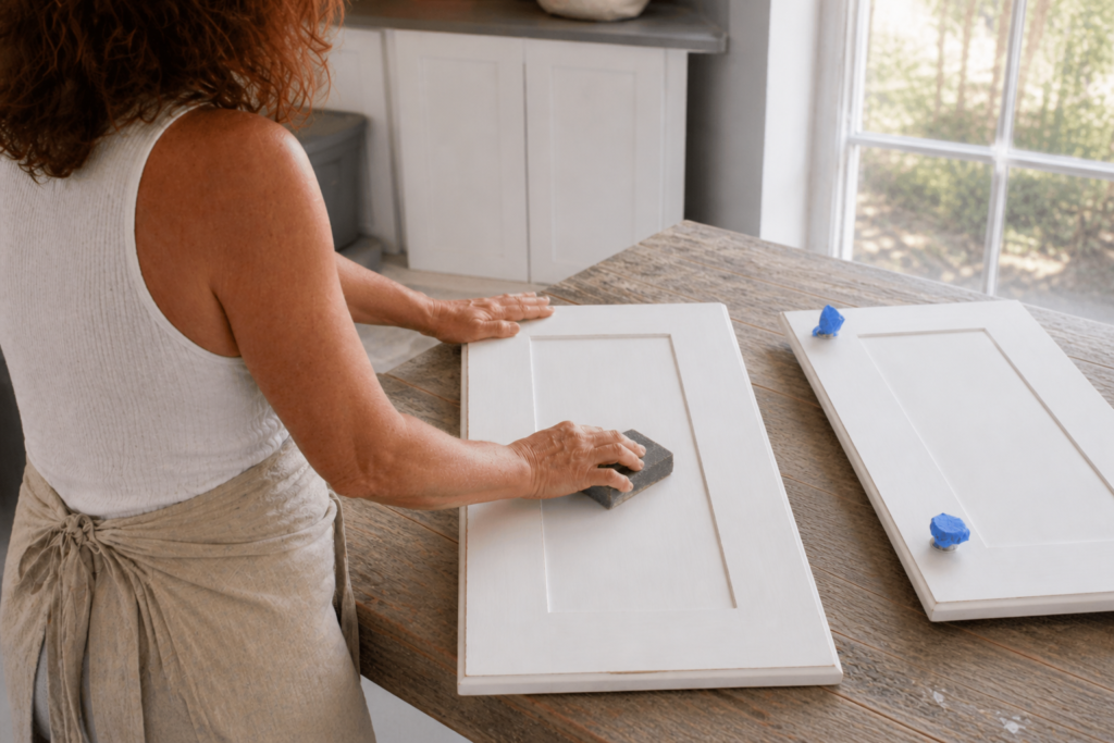 sanding the cabinetLaundry Room Cabinet Makeover for a Light and Natural Home